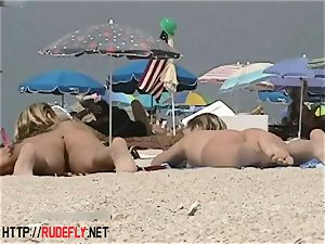 towheaded model naturist on the bare beach spycam video